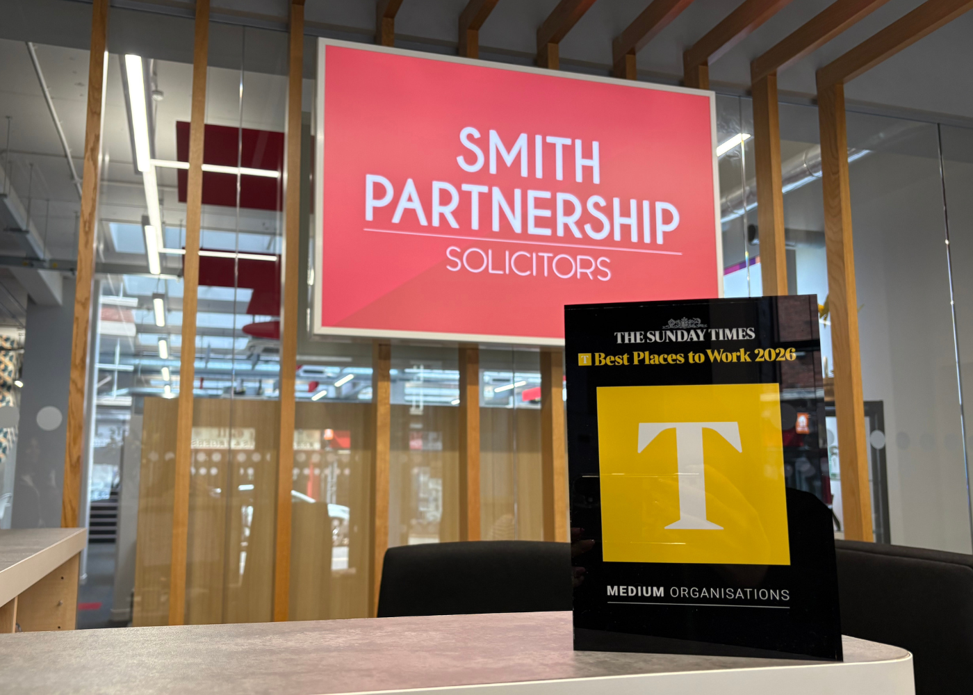 Trophy displayed in front of the Smith Partnership logo