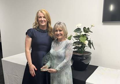 Claire Twells, Partner, with Julie Tomasik after winning her lifetime achievement award