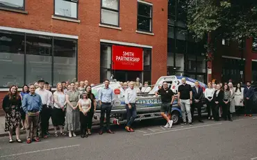 Vic Handley, with boat ‘City of Derby’, at law firm’s head offices in Friar Gate alongside the firm’s Management Committee and Staff