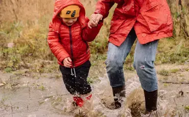 Child and Mum playing in mud