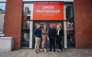 partners stood outside office