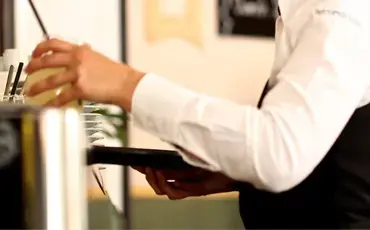 Employee clearing glasses