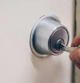 hand-using-key-in-door
