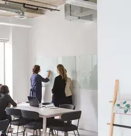 Office Workers Brainstorming Ideas on a Board
