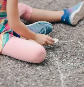 Child Drawing on Pavement with Chalk