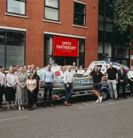 Vic Handley, with boat ‘City of Derby’, at law firm’s head offices in Friar Gate alongside the firm’s Management Committee and Staff