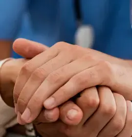 Doctor holding patient's hand