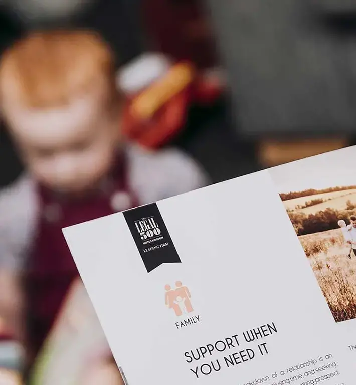 Family support brochure with two kids in the background
