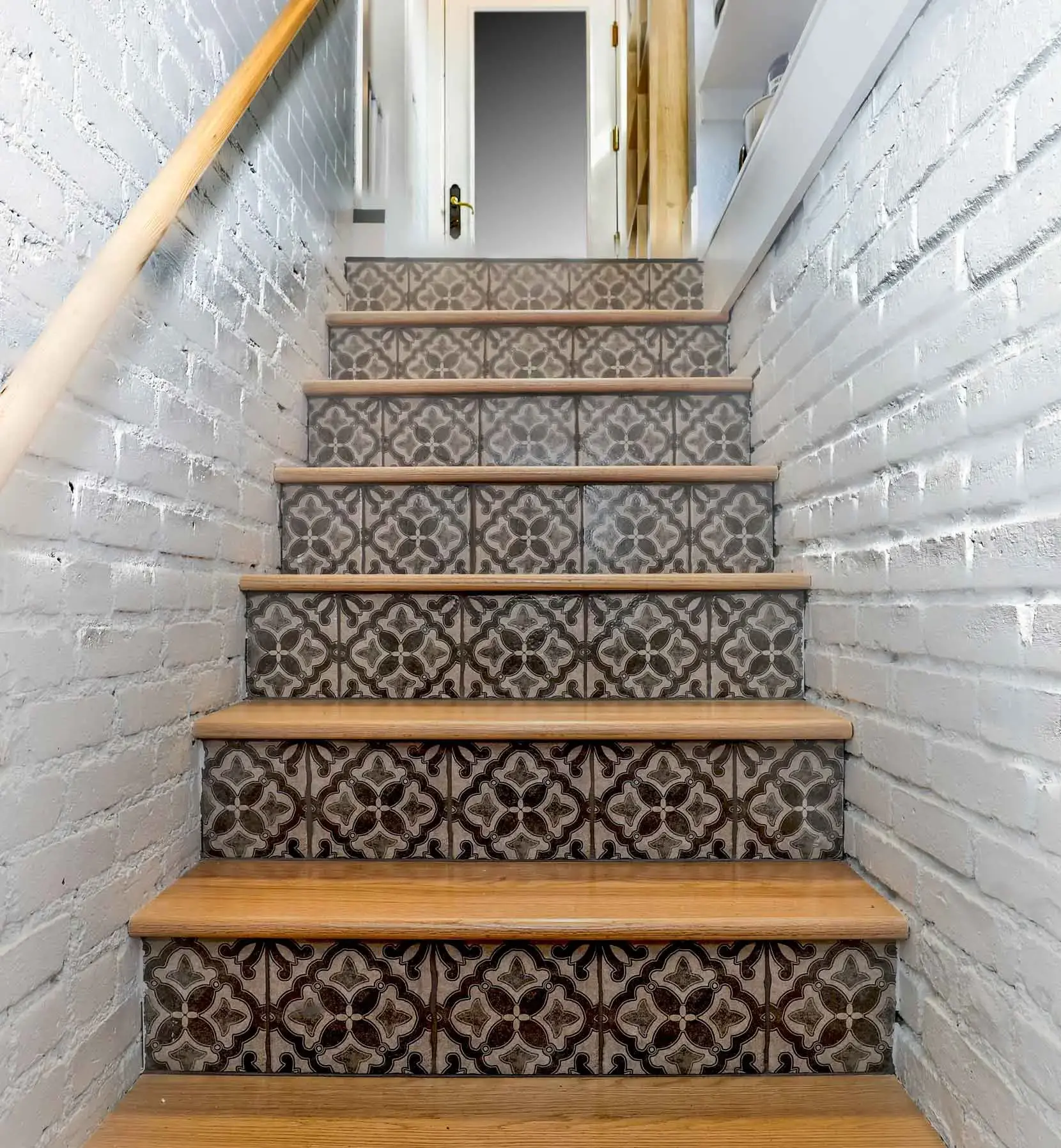 patterned stairs with white walls on side