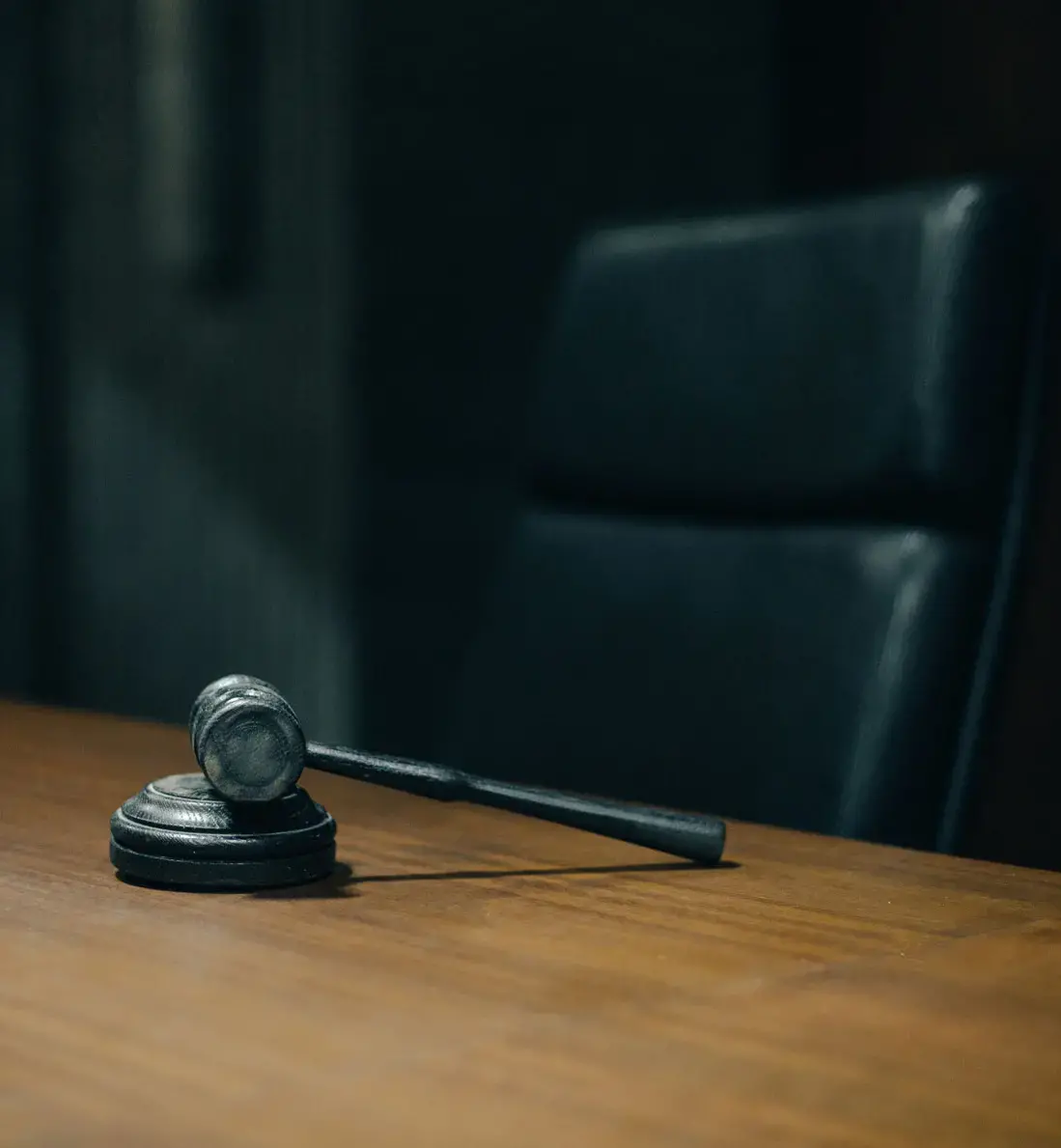 A Resting Gavel on a Table with Black Chair