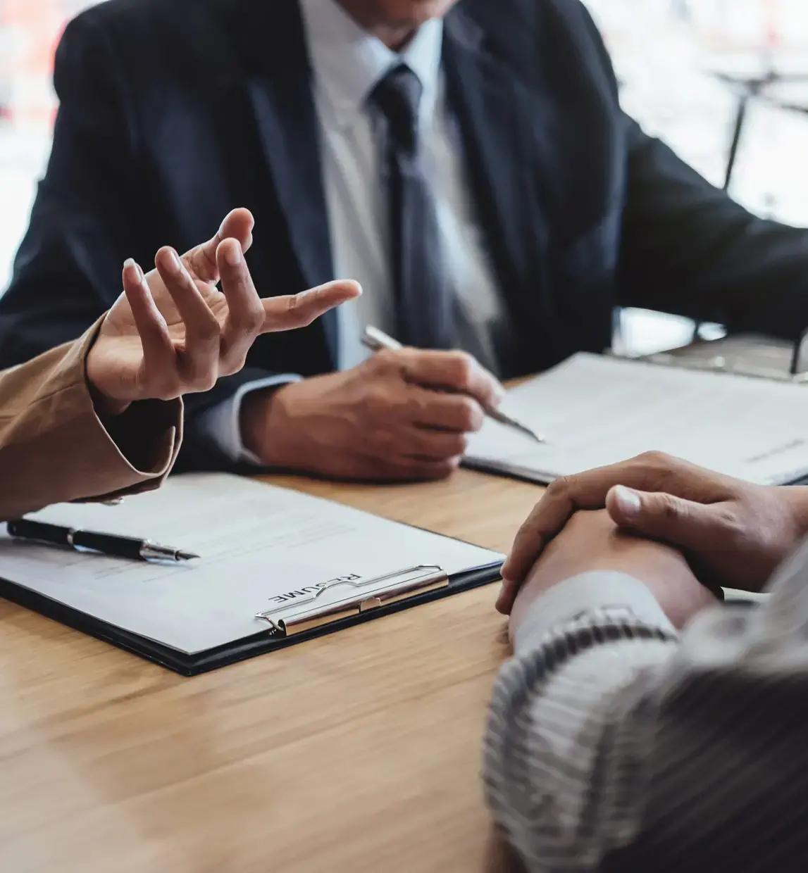 Person in Interview with CV on Table