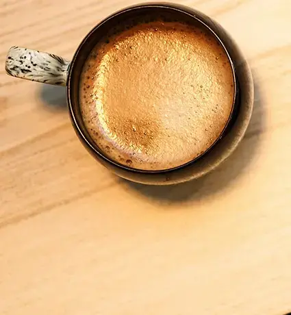 Two coffee cups on a table.
