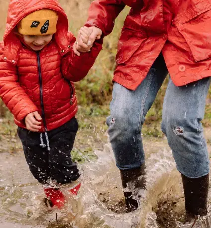 Child and Mum playing in mud