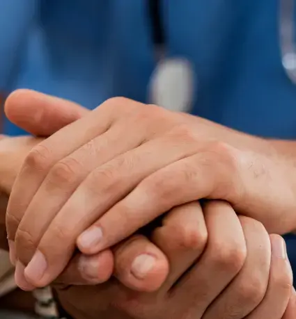 Doctor holding patient's hand
